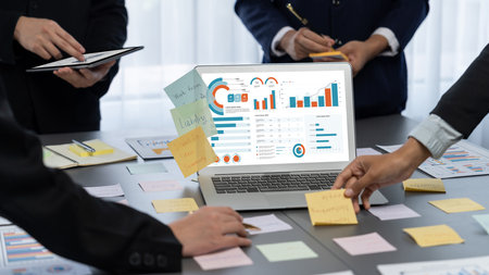 Analyst team use sticky note for creative and analytic brainstorm for business idea with data dashboard on laptop screen. Analysis financial data visualization tech for marketing strategy.の写真素材