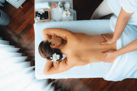 Panorama top view woman customer enjoying relaxing anti-stress spa massage and pampering with beauty skin recreation leisure in day light ambient salon spa at luxury resort or hotel. Quiescentの写真素材