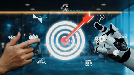 A digital illustration showcasing a human hand and a robotic hand collaboratively targeting a virtual goal within a high-tech business setting, emphasizing innovation.の写真素材
