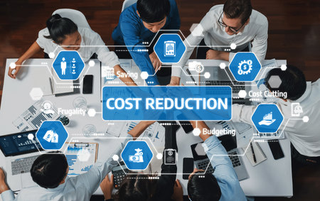 Team Collaboration on Cost Reduction Strategies in a Modern Office Setting with Hands and Technology in Focus. Amityの写真素材
