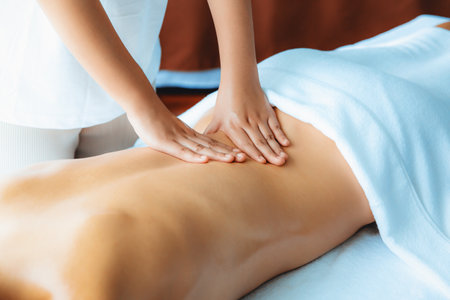 Caucasian woman customer enjoying relaxing anti-stress spa massage and pampering with beauty skin recreation leisure in day light ambient salon spa at luxury resort or hotel. Quiescentの写真素材