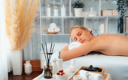 Caucasian woman customer enjoying relaxing anti-stress spa massage and pampering with beauty skin recreation leisure in day light ambient salon spa at luxury resort or hotel. Quiescentの写真素材