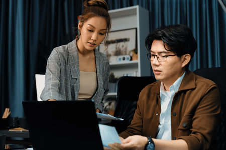 Managers discussing on document paperwork together for business planning on market share data at...