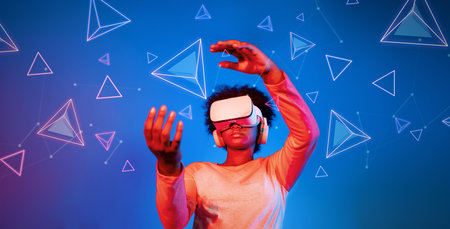 African girl with VR glasses standing at blue and pink background and looking at floating geometric...