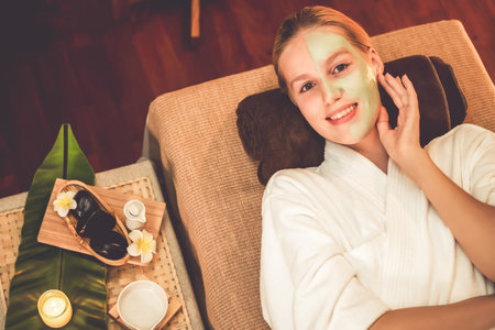 Serene ambiance of spa salon, woman customer smiling and rejuvenating with luxurious face cream...