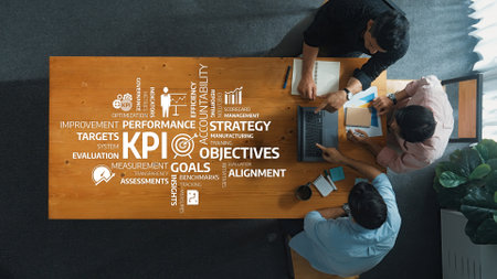 A group of professionals engaged in a strategic planning session, focusing on performance metrics and KPIs to enhance business objectives and foster effective teamwork in a modern workspace.の写真素材