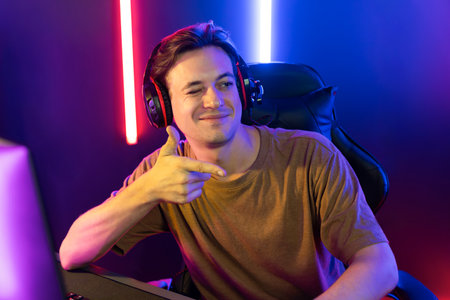 Host channel of gaming smart streamer playing online game to be winner, wearing headphone with...