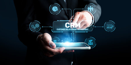A business professional interacts with cutting-edge CRM technology on a smartphone, illustrating the importance of customer relationship management in today digital landscape.の写真素材