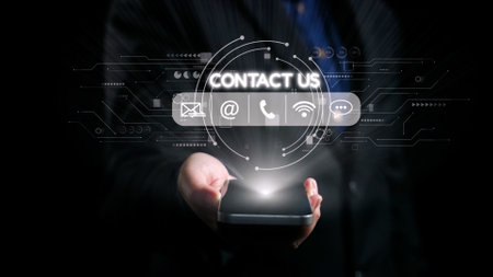 A hand holds a smartphone, featuring glowing digital icons like contact us, email, and phone, showcasing the essence of modern connectivity and technology in communication. Qubitの写真素材