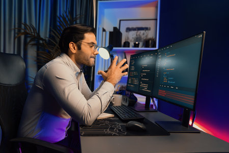 Working smart IT developer analyzing data software development on two pc screen, creating...