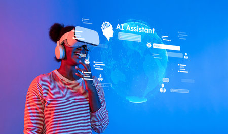 A young individual using a virtual reality headset interacts with a digital AI Assistant, surrounded by vibrant visuals in a modern technology setting.の写真素材