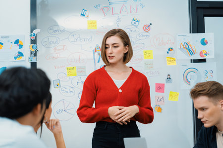 Professional attractive female leader presents creative marketing plan by using brainstorming mind mapping statistic graph and colorful sticky note at modern business meeting room. Immaculate.の写真素材