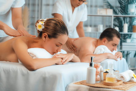 Caucasian couple customer enjoying relaxing anti-stress spa massage and pampering with beauty skin recreation leisure in day light ambient salon spa at luxury resort or hotel. Quiescentの写真素材