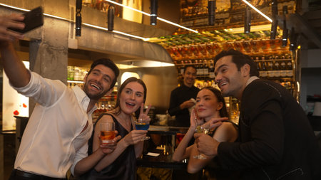 Circle of friends or couple standing fronted bar making selfie smiling with cocktail in Paloma,...
