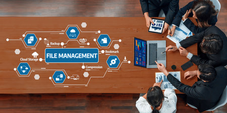A top view of a collaborative team meeting focused on file management strategies featuring digital tools, technology, and discussions to enhance data organization and efficiency.の写真素材