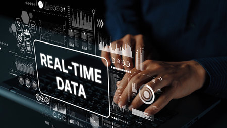 Hands Typing on Laptop with Digital Graphics Representing Real-Time Data Analysis and Technology Concepts. Asymptotic smart data analytic.の写真素材