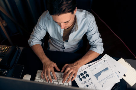 Top view smart businessman analyzing business paragraph dynamic database marketing analysis plan surrounded paper sheet, pc monitor report to compare with document data at home office. Pecuniary.の写真素材