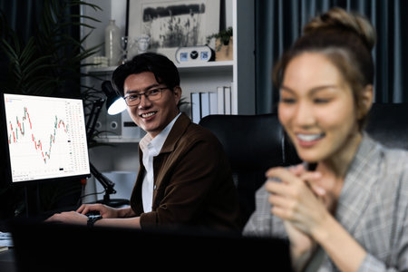 Successful Asian smiling businesswoman trader fronted blurry with partner focusing on back side in...