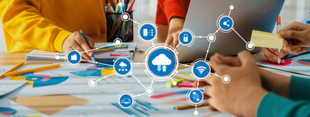This image captures a collaborative workspace where individuals engage in computing and cloud...