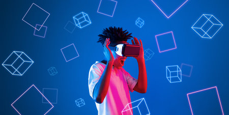 Smart boy standing at blue background while floating geometric shape. African man playing game and...