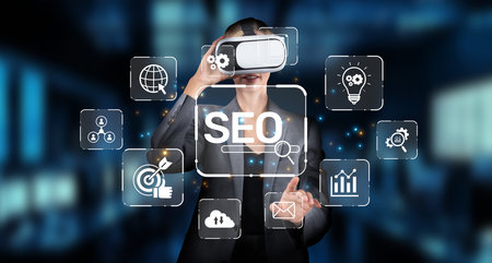 A professional engages with virtual reality technology to explore SEO strategies. The digital interface features icons that symbolize key elements of search engine optimization.の写真素材