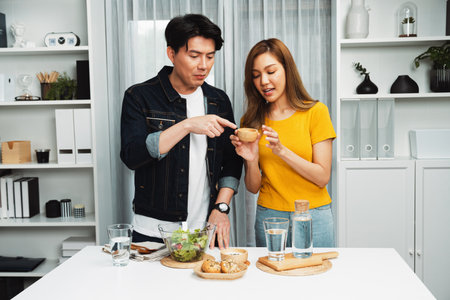Cooking show on live streaming with two chef influencers teaching mixed salad with dressing for easy special menu at home. Ingredients placing on table with bread bun wholegrain side dish. Infobahn.の写真素材
