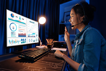 Host channel Asian influencer talking in broadcast wearing headsets on social media with pc in business graph screen, greeting listeners and coaching market online at neon modern studio. Stratagem.の写真素材