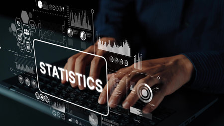 Professional analysis of statistics data displayed on screen with hands typing on a laptop keyboard in modern workplace environment. Asymptotic smart data analytic.の写真素材