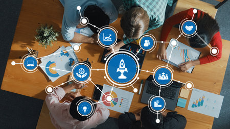 Aerial view of a diverse team collaborating in a modern office, surrounded by business analytics...