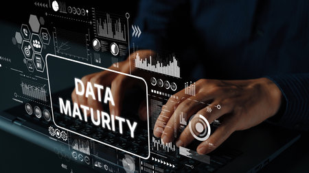 Hands Typing on Laptop with Overlay Graphics Illustrating Data Maturity in a Digital Environment. Asymptotic smart data analytic.の写真素材