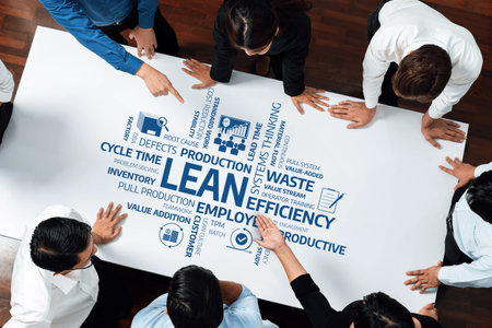 A diverse group of professionals collaborates around a whiteboard, focusing on lean management...