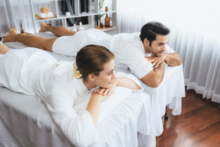 Caucasian couple customer enjoying relaxing anti-stress spa massage and pampering with beauty skin recreation leisure in day light ambient salon spa at luxury resort or hotel. Quiescentの写真素材