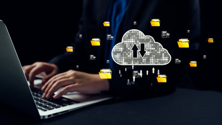This image illustrates modern cloud computing concepts with a person using a laptop, integrating digital file management and efficient data storage solutions in a dark setting.の写真素材