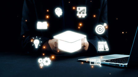 This image showcases the concept of education in a modern workspace, featuring glowing icons that symbolize various aspects of learning, technology, and business success. Qubitの写真素材