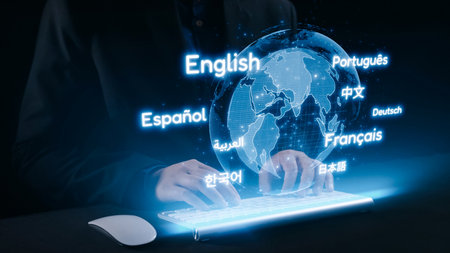 A close-up view of hands typing on a sleek keyboard, surrounded by a glowing globe that illustrates various languages and cultures in an advanced digital setting.の写真素材