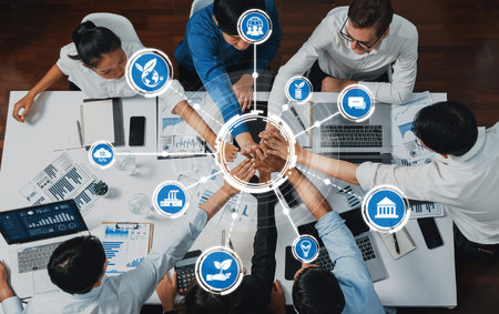 A dynamic business meeting scene featuring diverse individuals collaborating around a table, symbolizing teamwork and innovative solutions for a sustainable future. Amityの写真素材