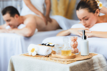Aromatherapy massage on daylight ambiance or spa salon composition setup with focus decor and spa accessories on blur woman enjoying blissful aroma spa massage in resort or hotel background. Quiescentの写真素材