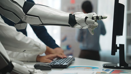 A robotic arm engages with a computer in a modern office, highlighting the blend of human ingenuity...