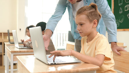 Smart boy using laptop in classroom. Diverse students learning programming in STEM technology class. Technology. Pedagogy.の写真素材