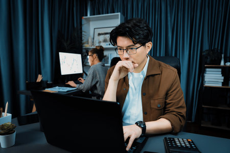 Serious face of thinking businessman focusing laptop to report data analysis social media online...