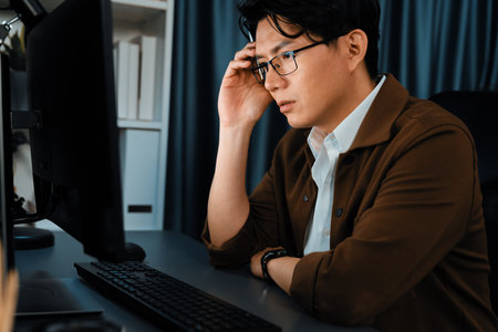 Smart businessman in casual day focusing computer to create business plan report over late night time at office, working on searching tools market planning with new startup company project. Infobahn.の写真素材