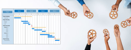 This image illustrates a collaborative approach to project management with hands holding gears and a Gantt chart, highlighting teamwork and effective planning strategies. Amityの写真素材