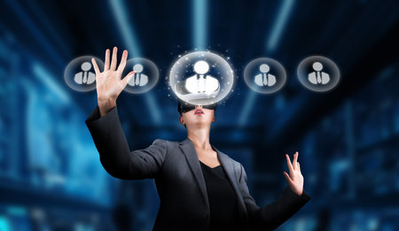 A professional woman engages with virtual reality technology, exploring networking and communication in a dynamic digital business environment, emphasizing innovation.の写真素材