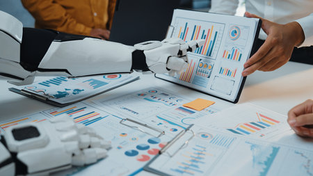 Explore the future of collaboration as a human and a robot analyze data together, surrounded by...
