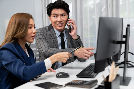 Businessman calling with business partner on mobile phone while calculating stock exchange value database with woman coworker on computer, analyzing company value sell or buy on up to date. Infobahn.の写真素材