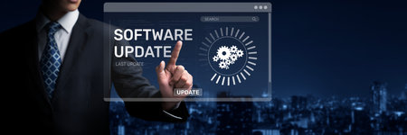 A businessman uses a digital interface to initiate a software update, showcasing modern technology...