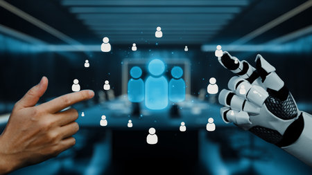 This image depicts a modern workspace where a human hand interacts with a robotic hand, showcasing...