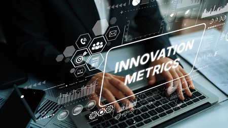 Business Professional Analyzing Innovation Metrics with Data Visualization on Laptop in Modern Office Setting. Asymptotic smart data analytic.の写真素材