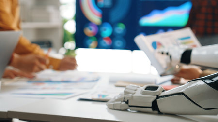 A modern office meeting showcasing a robotic arm alongside human colleagues discussing innovative...