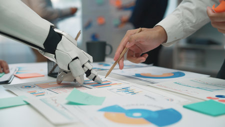 A modern office scene showcasing collaboration between a robotic hand and a human hand, analyzing...